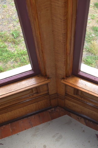 Front parlor window trim: cedar exposed by wall reconstruction colored.